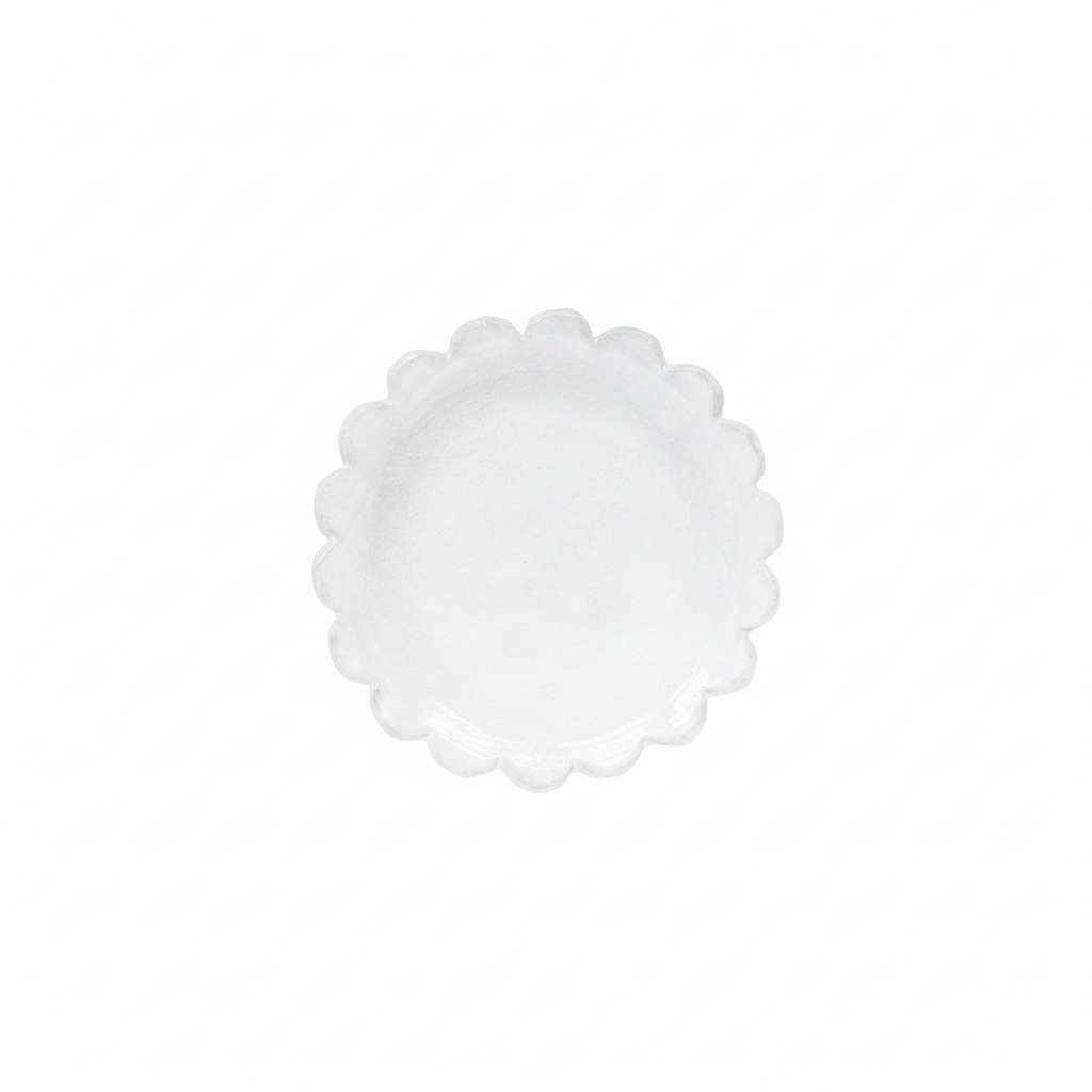 White scalloped-edge plate on a white background