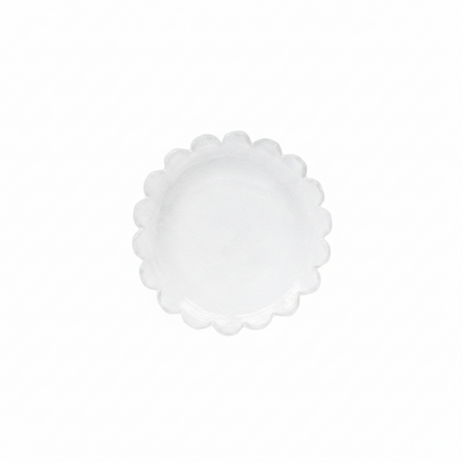 White scalloped-edge plate on a white background