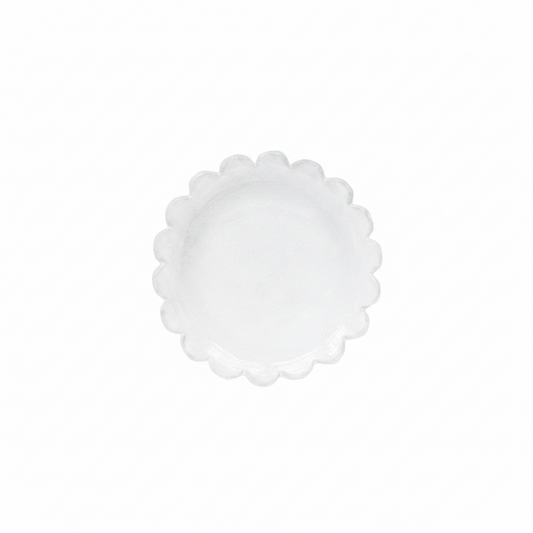 White scalloped-edge plate on a white background
