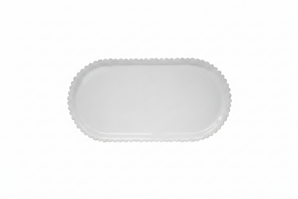 White ceramic platter with scalloped edge on a white background