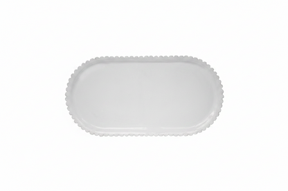 White ceramic platter with scalloped edge on a white background