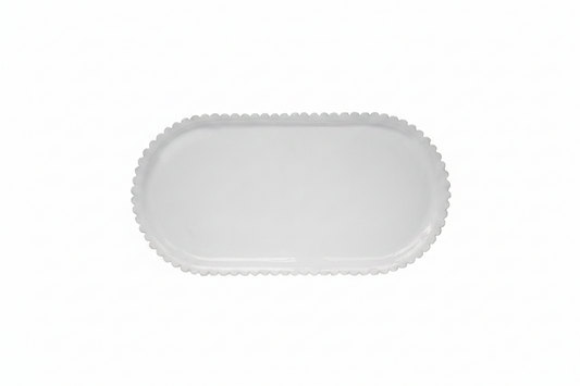 White ceramic platter with scalloped edge on a white background