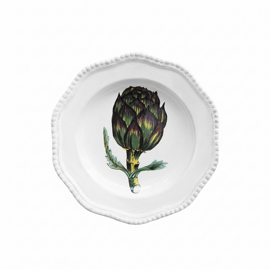 White plate with a decorative artichoke design on a white background