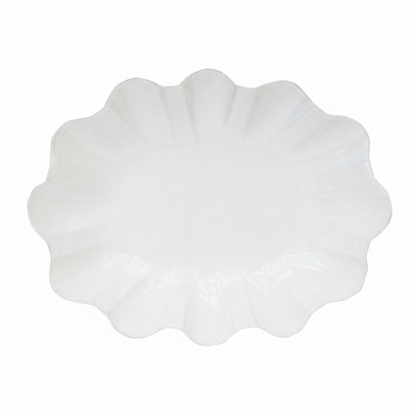White scalloped-edge plate on a white background