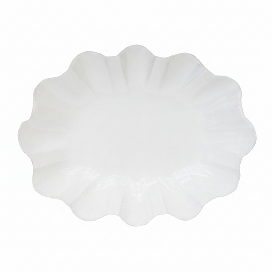White scalloped-edge plate on a white background