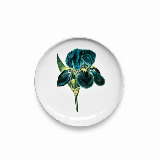Round ceramic plate with a blue iris flower design on a white background