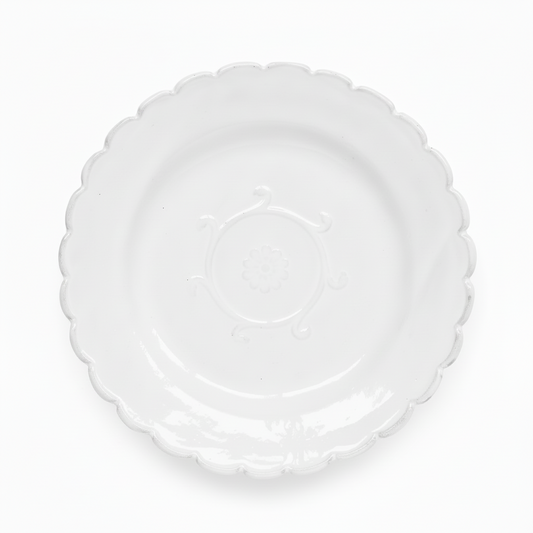 Clear plastic plate with scalloped edge on a white background