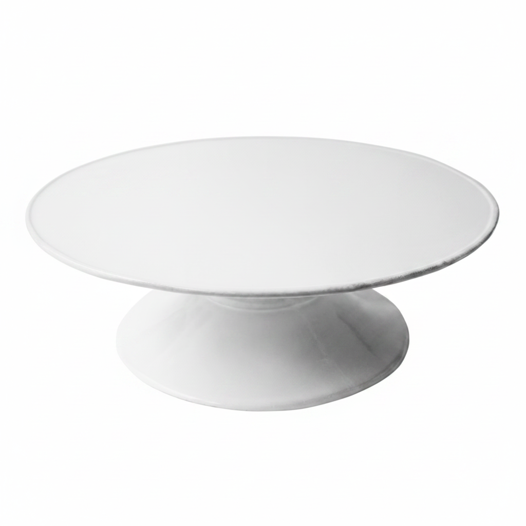 White ceramic cake stand on a white background