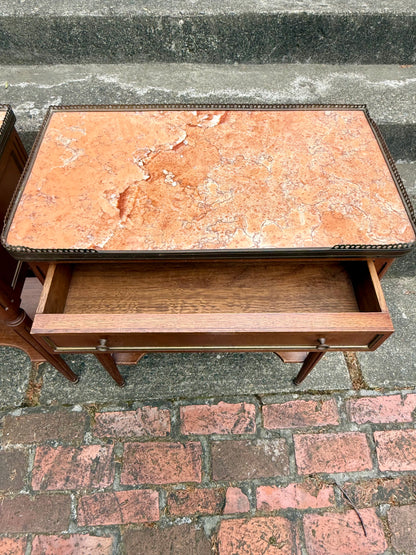 Marble-top table with a drawer on a stone pavement