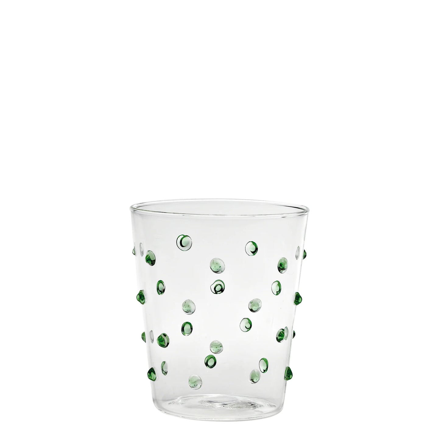 Clear glass tumbler with green dots on a white background