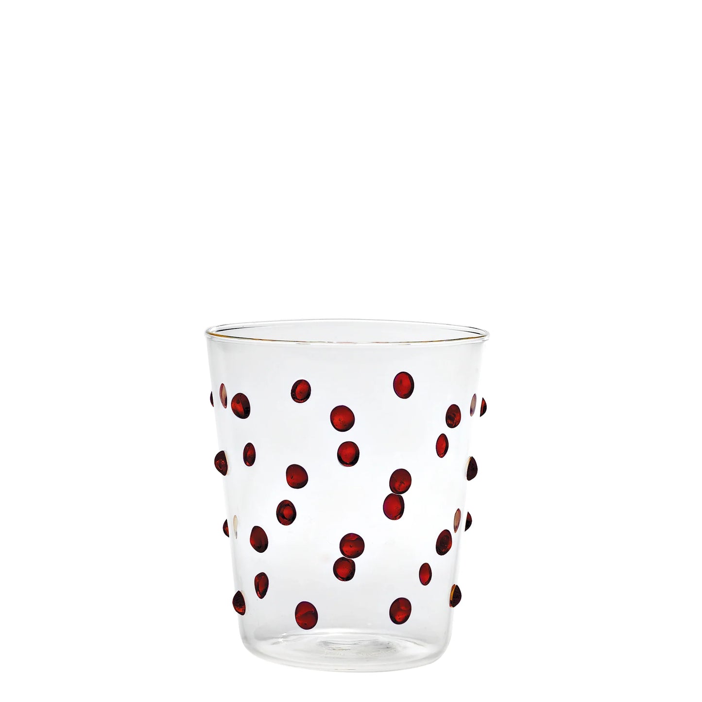 Clear glass tumbler with red polka dots on a white background