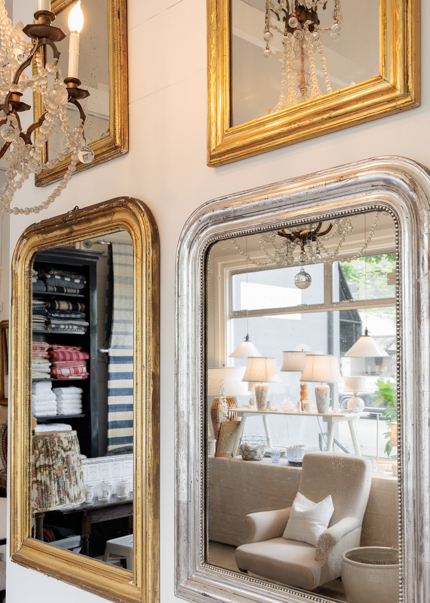 Decorative mirrors with gold and silver frames in the red ticking store.