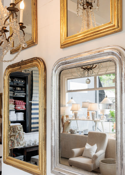 Decorative mirrors with gold and silver frames in the red ticking store.