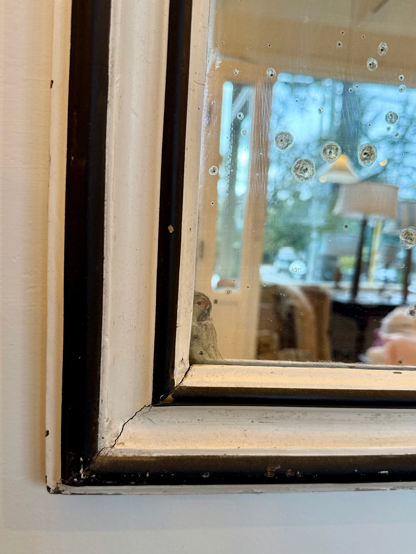 Close-up of a vintage mirror with markings on glass 