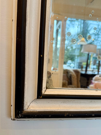 Close-up of a vintage mirror with markings on glass 