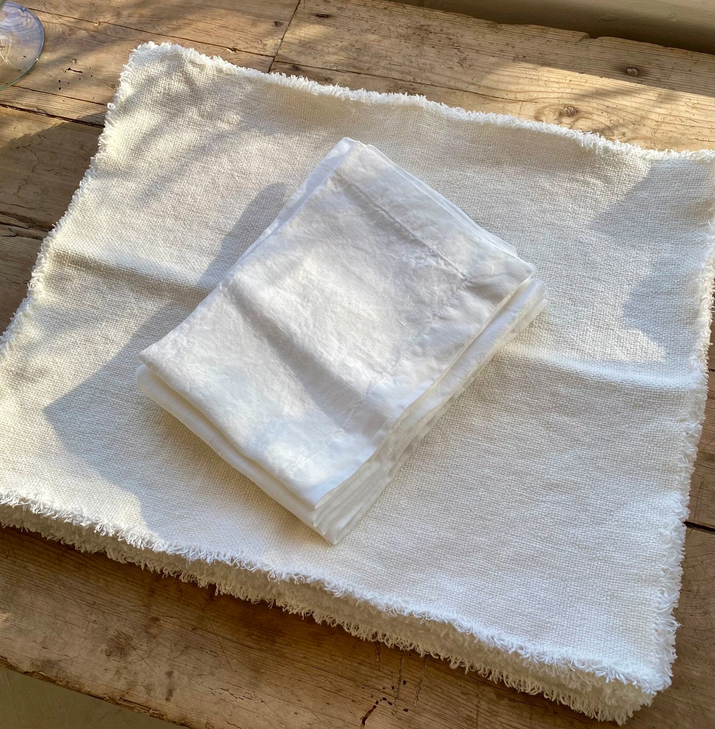 White folded tab napkin on a stack of more tab napkins